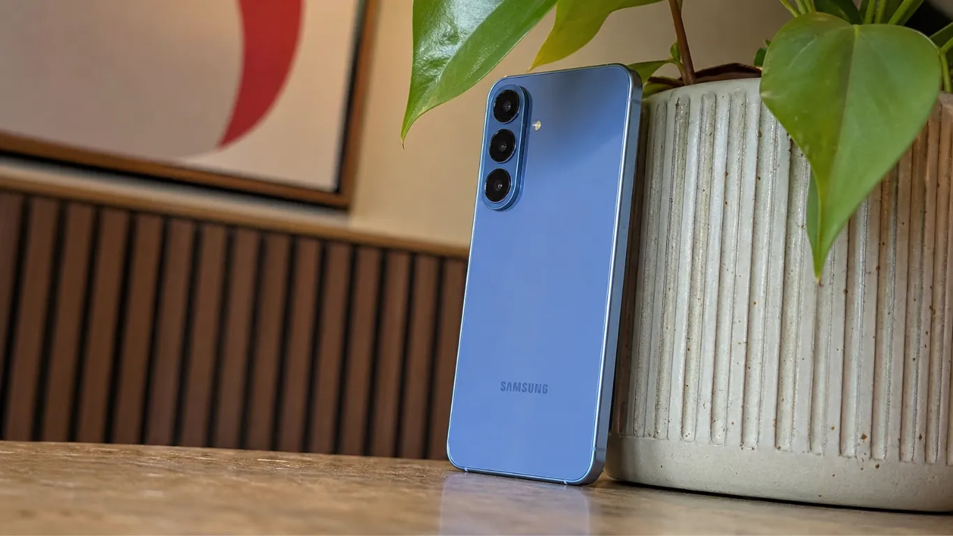 Samsung Galaxy S26 FE in the new Blueberry finish resting against a ribbed planter, highlighting its flat display edges and slim profile.